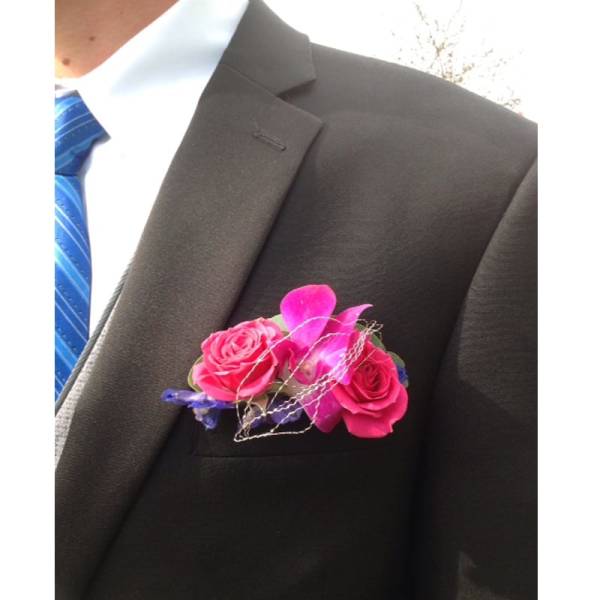 Pink rose boutonniere on a suit jacket lapel