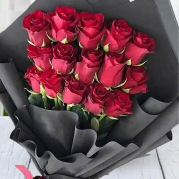 Bouquet of red roses wrapped in black paper
