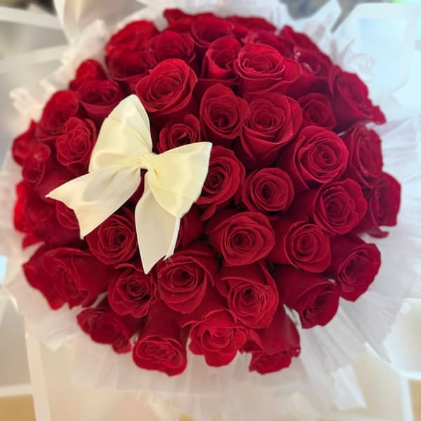 Bouquet of red roses with a white ribbon bow
