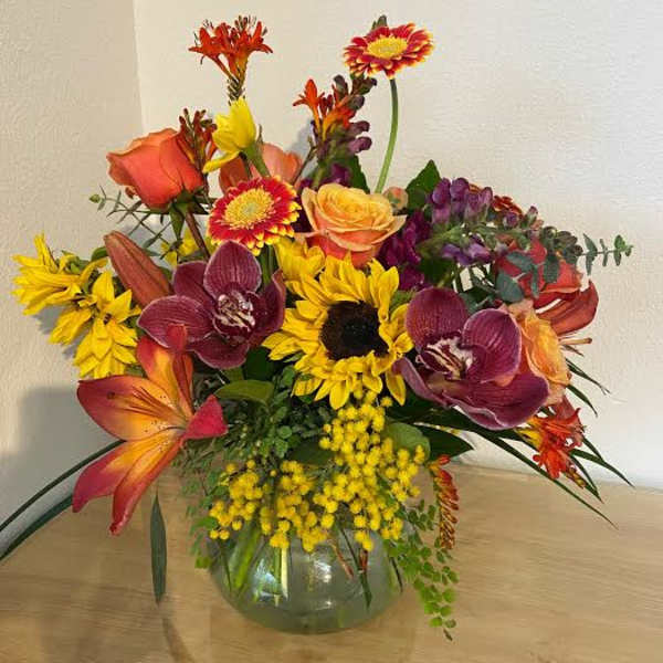 Mixed bouquet of bright flowers in a glass vase