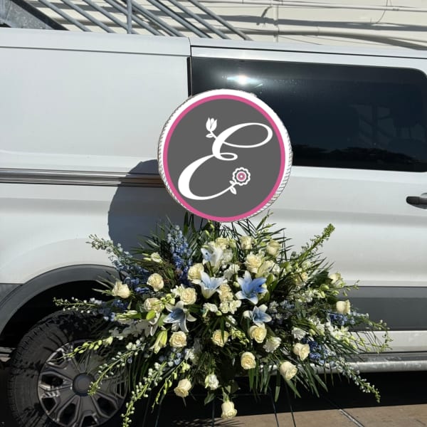 Large white and blue floral spray arranged on a vehicle