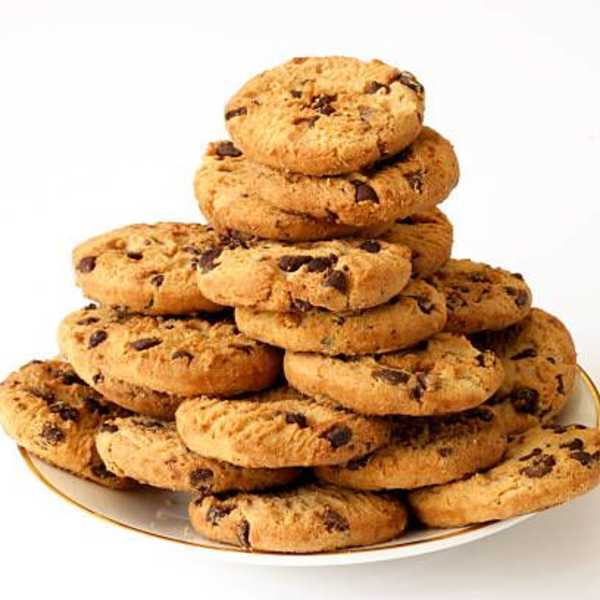 Stack of chocolate chip cookies on a white plate