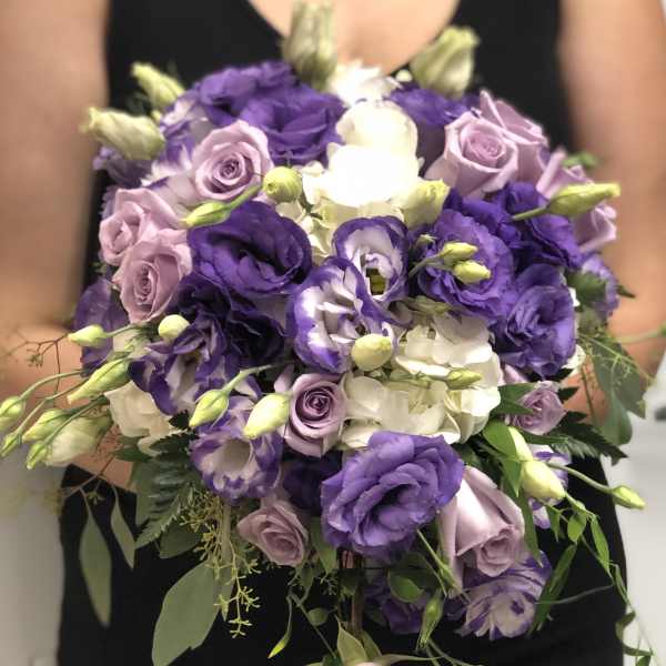 Bouquet of purple, lavender, and white flowers with greenery