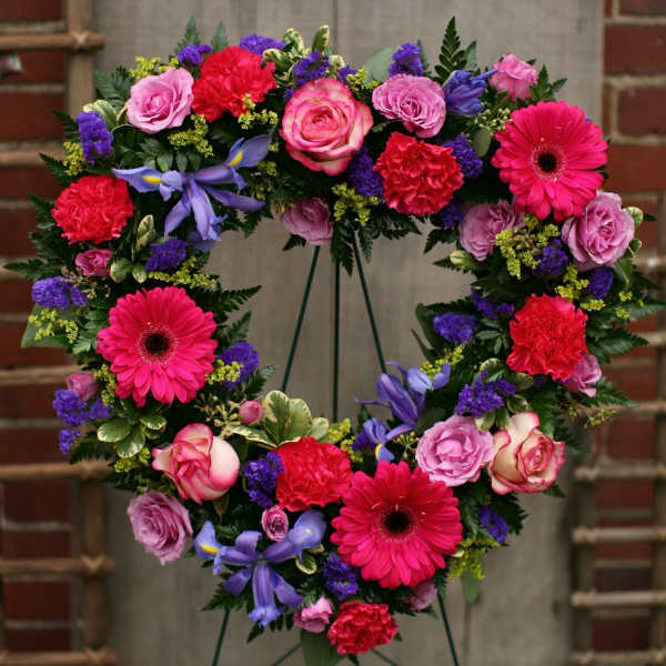 Heart-shaped floral wreath with pink, purple, and red blooms