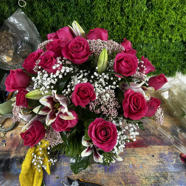 Bouquet of hot pink roses with lilies and baby's breath