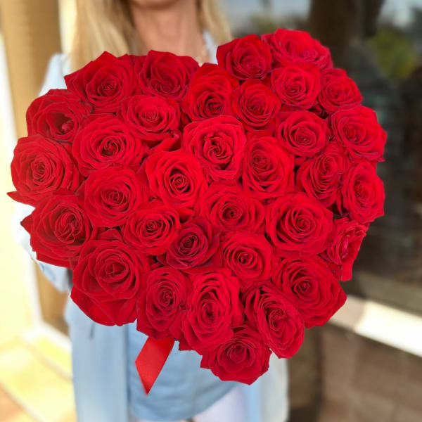 Large bouquet of red roses held by a person