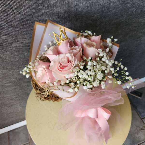 Pink rose bouquet with baby's breath and a gold crown pick