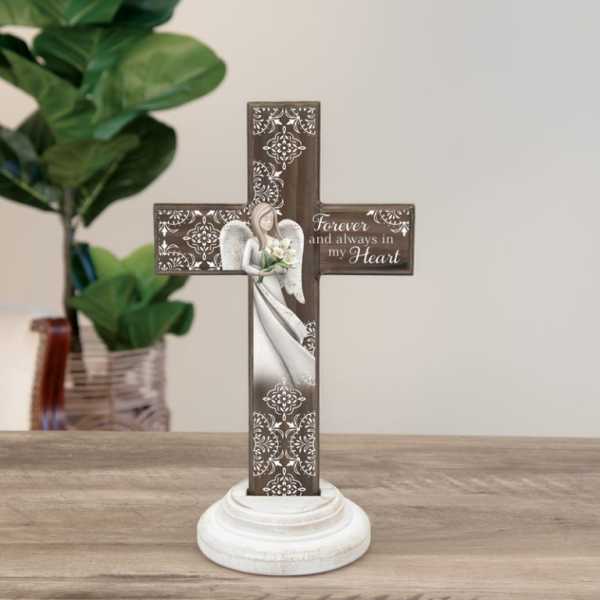 Decorative memorial cross on a white base with an angel and flowers