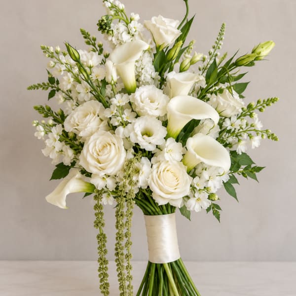 White bouquet with roses, calla lilies, and small filler flowers