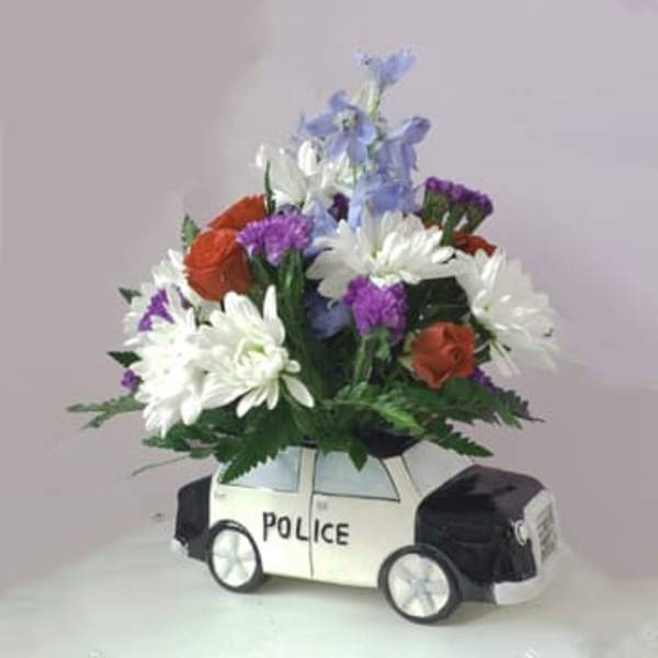 Flower arrangement in a police car-shaped container