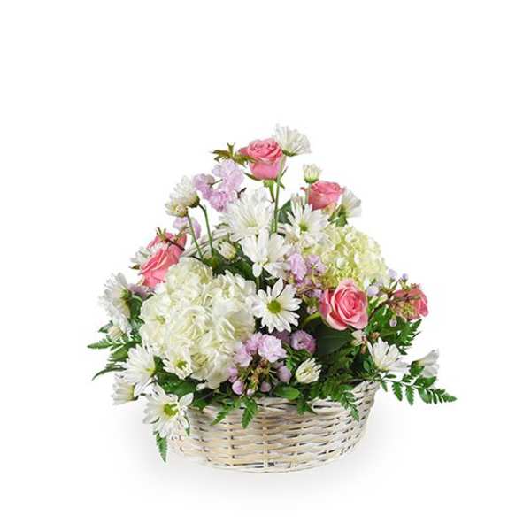 Pink roses and white daisies in a wicker basket