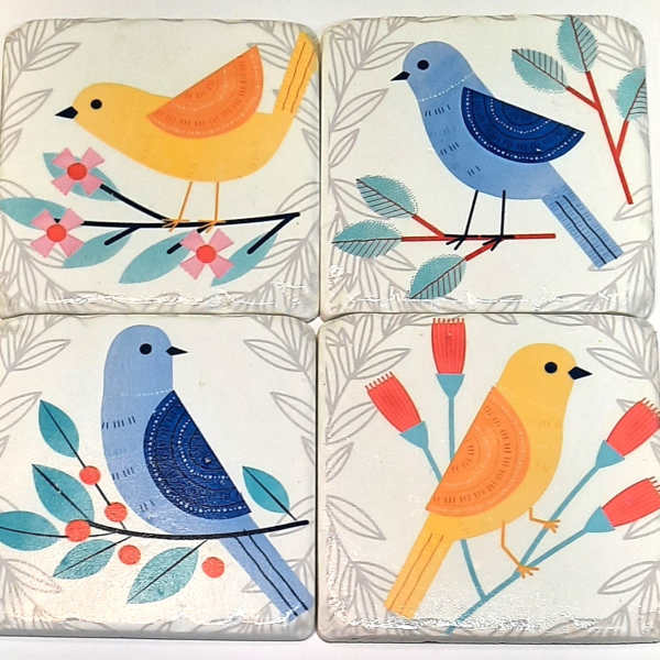 Four decorative bird tiles with floral branch patterns
