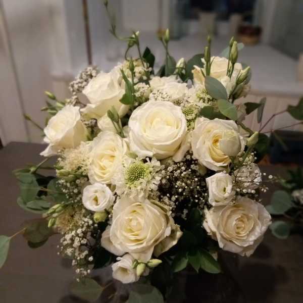Cream rose bouquet with white filler flowers and greenery