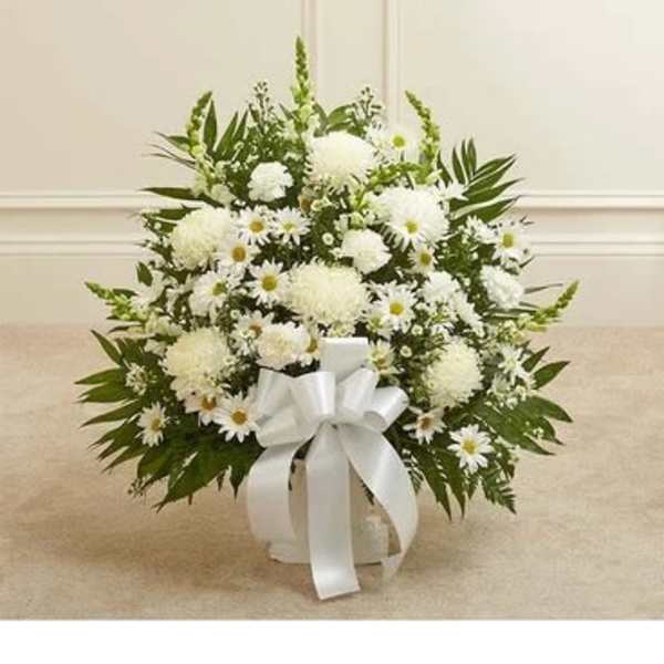 White floral arrangement in a white container with a ribbon bow