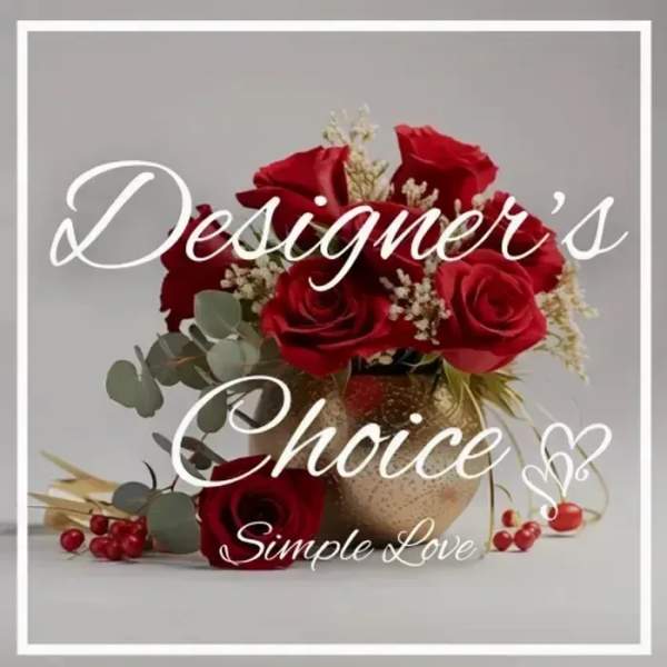 Red roses arranged in a gold vase with white filler flowers