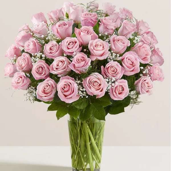 Pink roses arranged in a clear glass vase