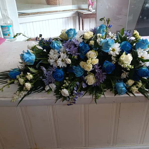 Large blue, white, and purple floral arrangement on a table