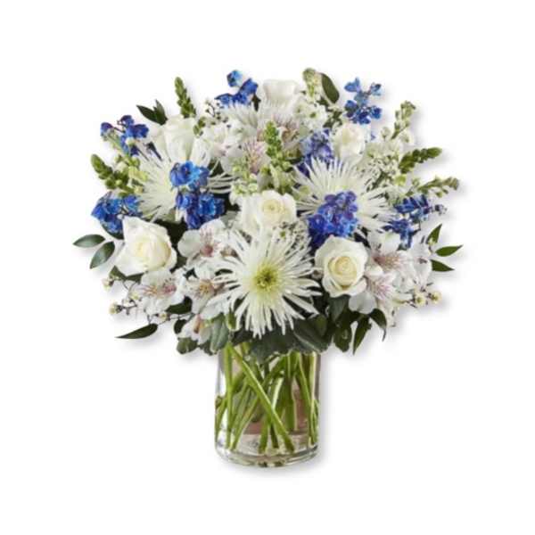 White and blue mixed bouquet in a clear glass vase