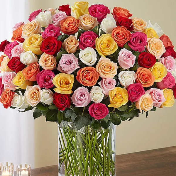 Large bouquet of multicolored roses in a clear glass vase