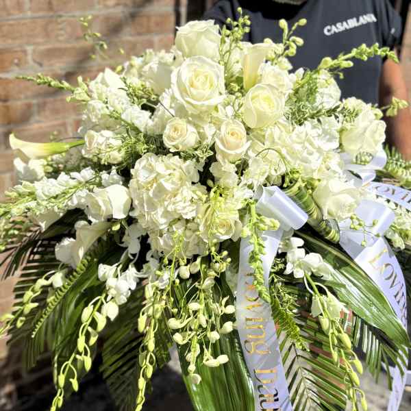 White rose and hydrangea bouquet with trailing greenery and ribbon