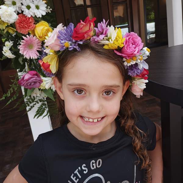 Girl wearing a colorful flower crown with mixed blooms