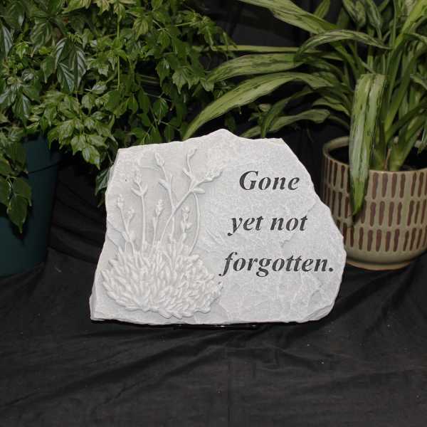 Memorial stone with floral relief and the words "Gone yet not forgotten."