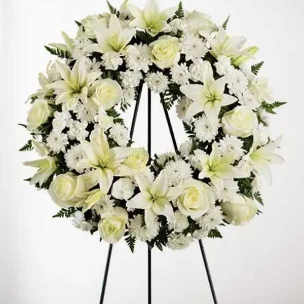 White floral wreath on a black easel