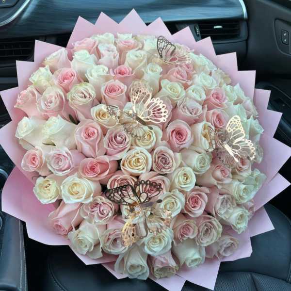 Large bouquet of pale pink and white roses with butterfly picks