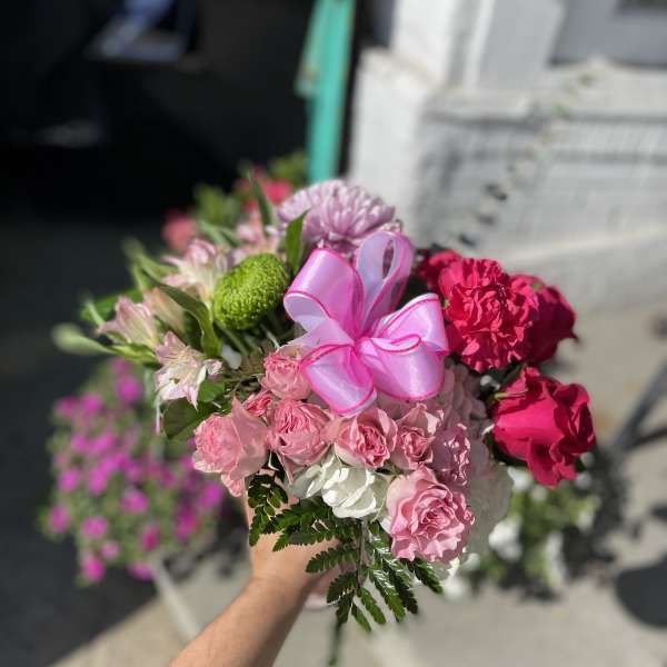 Pink and white bouquet with a ribbon bow and mixed blooms