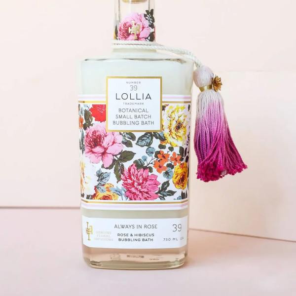 Floral-patterned bath bottle with a pink tassel and gold cap