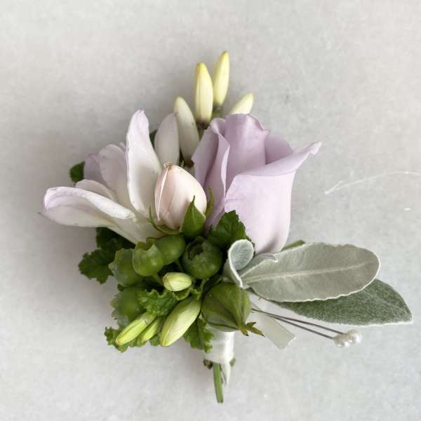 Small boutonniere with pale lavender and white flowers