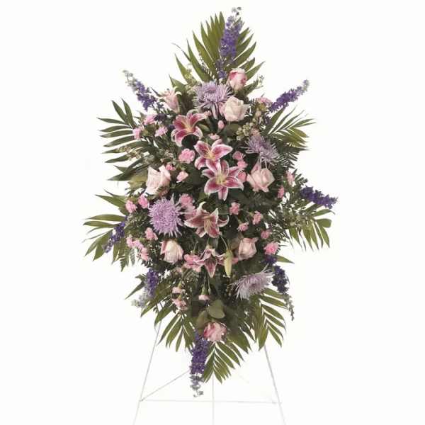 Standing funeral spray with pink and purple flowers on an easel