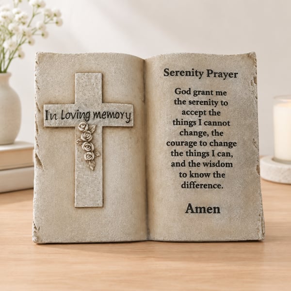 Decorative memorial plaque shaped like an open book with a cross and prayer text