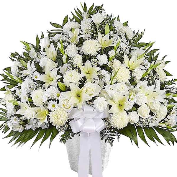 White funeral spray with lilies, roses, and chrysanthemums in a vase