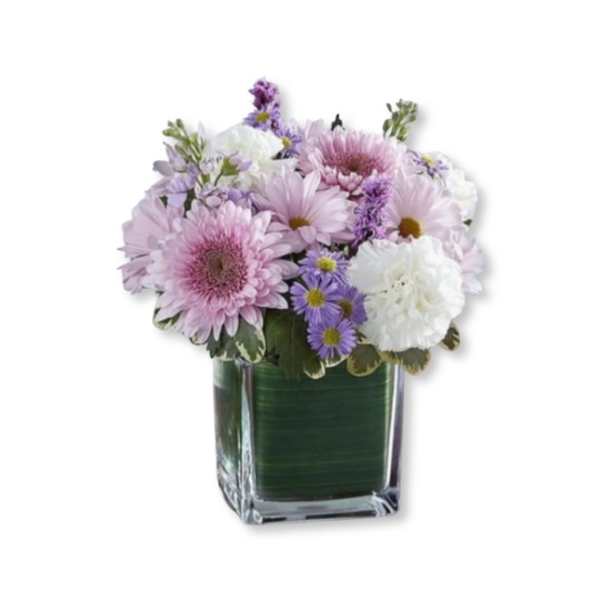 Pink and white flowers arranged in a square glass vase
