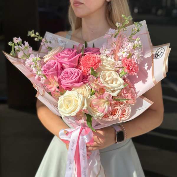 Bouquet of pink and white roses with small pink filler flowers