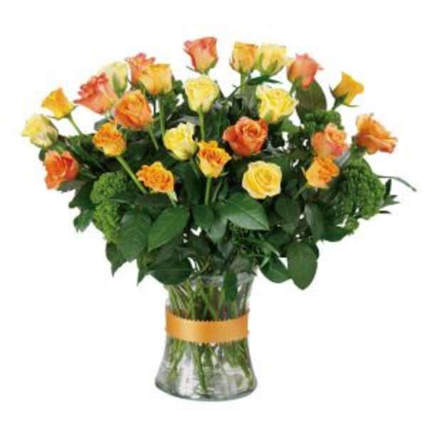 Bouquet of yellow and orange roses in a clear glass vase