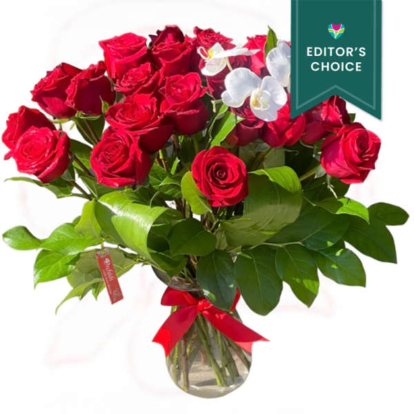 Bouquet of red roses with white orchids in a glass vase