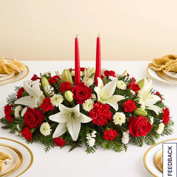 Red and white floral centerpiece with two red candles