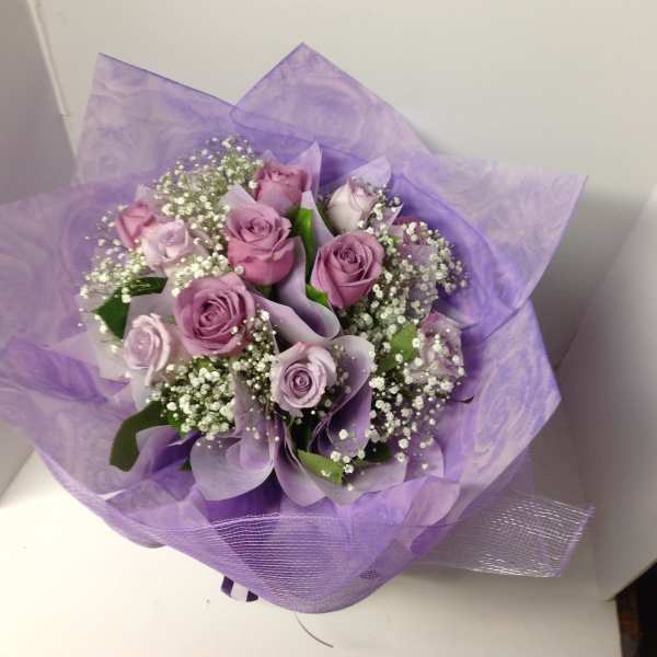 Lavender rose bouquet wrapped in purple paper