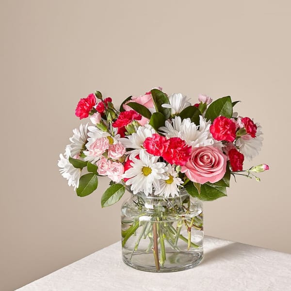 Pink and white mixed bouquet in a clear glass vase