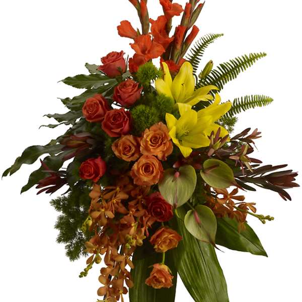 Tall floral standing spray with orange and yellow flowers on a metal easel