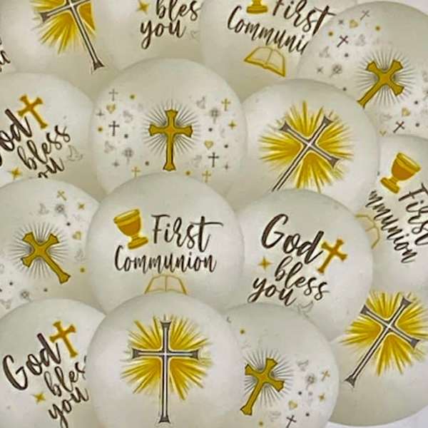 White communion balloons with gold cross designs and text