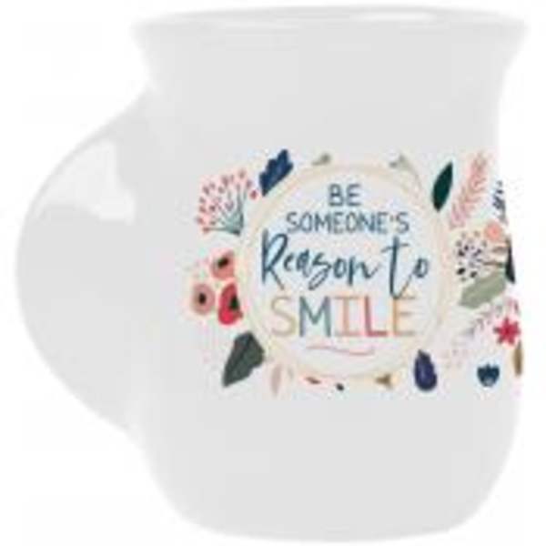 White mug with floral print and the words "Be someone's reason to smile"
