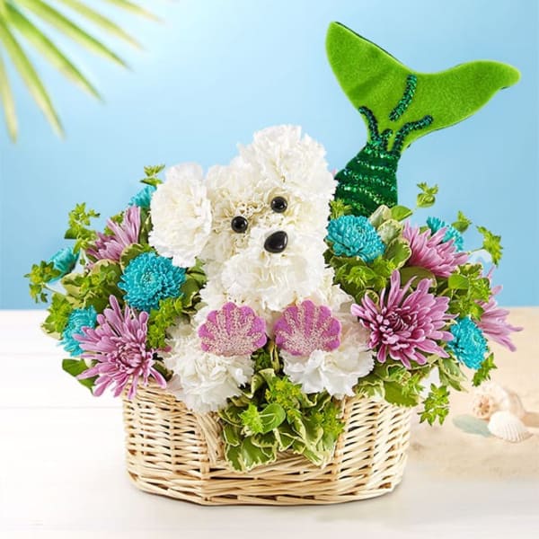 Basket arrangement with a white flower dog and colorful blooms