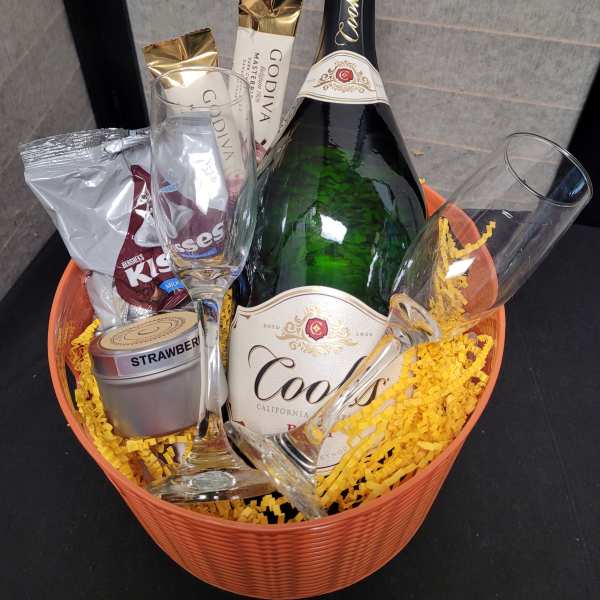 Gift basket with champagne, chocolates, and two flutes