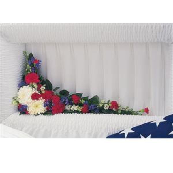 Casket spray with red, white, and blue flowers