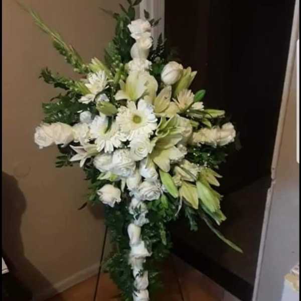 White floral standing spray on an easel