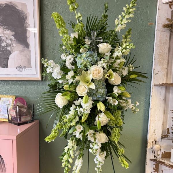 Tall white and green floral standing spray with roses and lilies