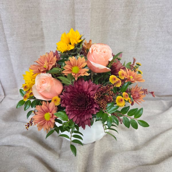 Mixed bouquet of roses and chrysanthemums in a white vase